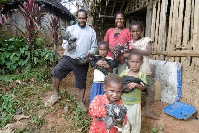 Steve, Elma and family with chickens - Oxfam PNG.JPG